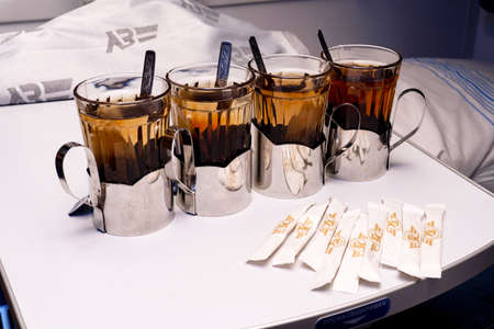 2020 February 28, Ukrzaliznytsia train, Four glasses with tea in metal holders on table at the train, travel concept.のeditorial素材