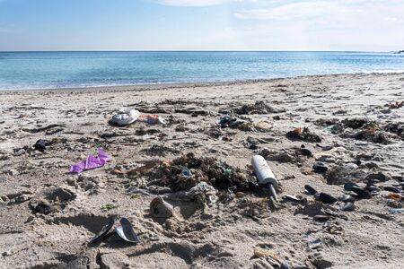 Trash at the beach near sea or ocean. No plastic and global diseases concept. Save the world, keep clean environment. There is space for text. Good background.の写真素材