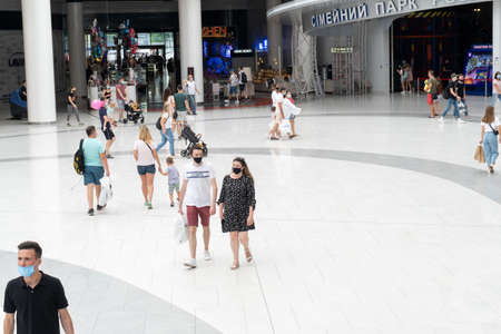 Kiev, Ukraine, July 4 2020, caucasian ukranian people at protective masks walking at Lavina shopping mall, having fun and shopping, new reality concept after lockdown.のeditorial素材