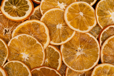 Close up of sliced dried oranges, many slices of tangerines, as background or texture, view from the...