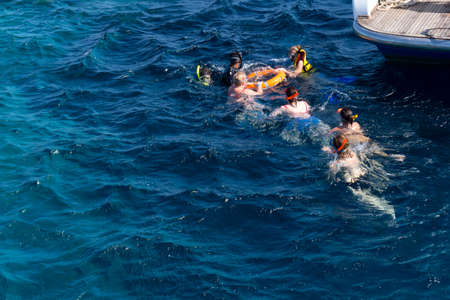 Group of people at swimming suits snorkeling at blue sea, summer time.の写真素材
