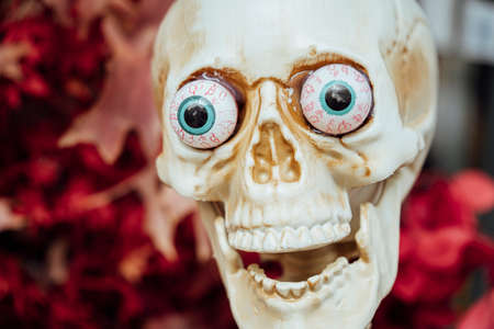 Halloween decoration near cafe or restaurant, modern skeletons sitting, talking, using mobile phones, having fun like people outdoor.の写真素材