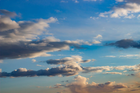 Abstract painting of whimsical clouds against a blue sky.