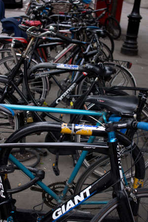 telephoto view of a row of bicycles locked up to outdoor bike parking railsのeditorial素材