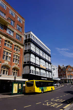 House of Fraser department store in central Bournemouth with a Yellow bus at the bus stop in front on a sunny dayのeditorial素材