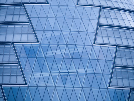 close-up of the London Assembly building showing the distinct pattern in the glass with a cool blue...