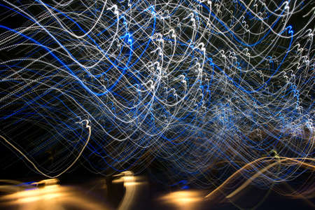 abstract light streaks background pattern against blackの写真素材