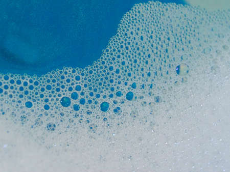 Semi-abstract picture of the pattern of white bubbles against a blue backgroundの写真素材