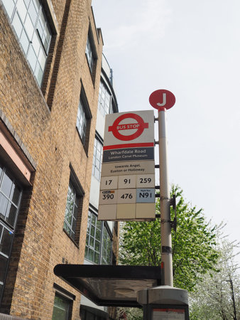 A bus stop in London showing the London transport roundel, location of the bus stop and the number...