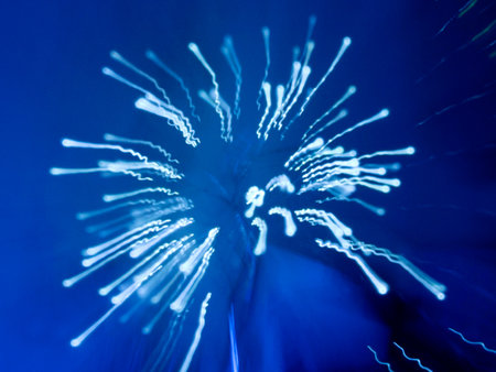 Abstract blue light streaks against a dark blue backgroundの写真素材
