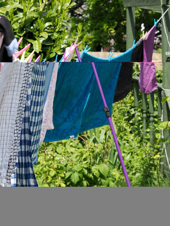 washing or laundry drying in the sun and breeze on a washing lineの写真素材