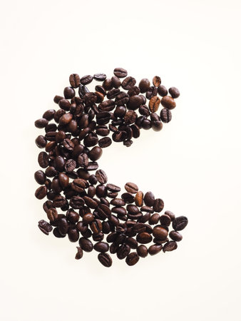 Coffee beans isolated on a white background and formed into the shape of a C