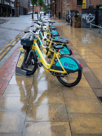 a line of hire bicycles docked in Manchester City centre 2026