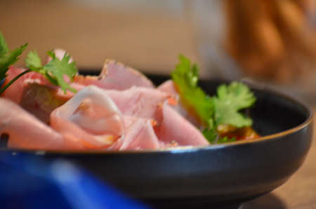 local homemade sausages, ham, olives on a wooden board salad black Plate, backgroundの写真素材
