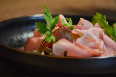 local homemade sausages, ham, olives on a wooden board salad black Plate, backgroundの写真素材