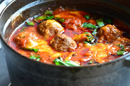 Meatballs in tomato sauce with herbs in a casserole panの写真素材