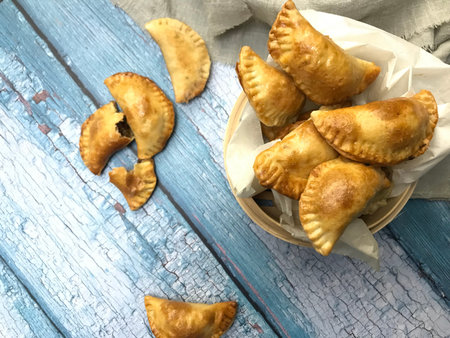 Homemade empanadas with meat on a blue wooden background.の写真素材