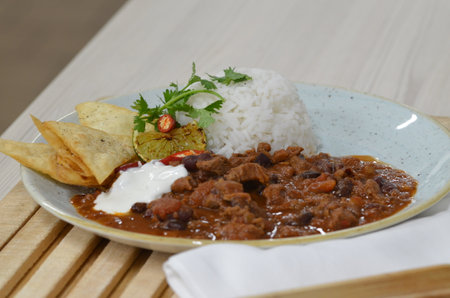 Beef and chili con carne served with rice and nachosの写真素材