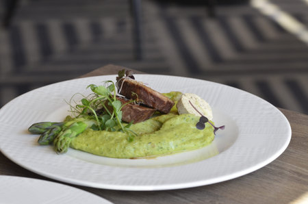 beef fillet with asparagus and mashed potatoes on a white plateの写真素材