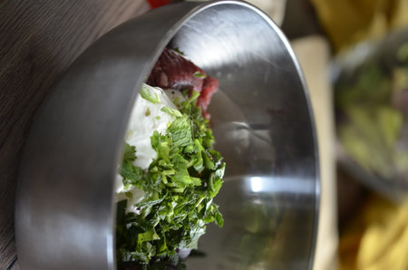 Delicious salad in a stainless steel bowl. Selective focus.の写真素材