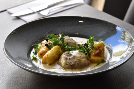 Chicken fillet with mushroom sauce and arugula on a plateの写真素材