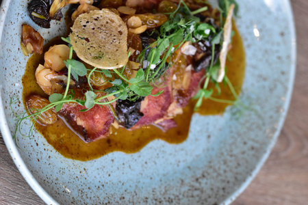 Czech food, beef tongue carpaccio with sauce on wooden table