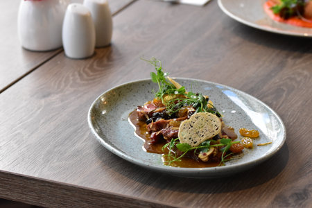 Czech food, beef tongue carpaccio with sauce on wooden tableの写真素材