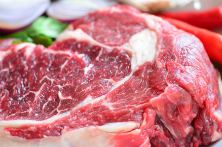 raw beef steak with red hot chili pepper, parsley and garlicの写真素材