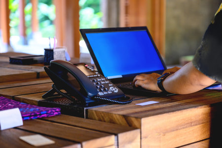 Close up of businesswoman hand using laptop computer in coffee shop.
