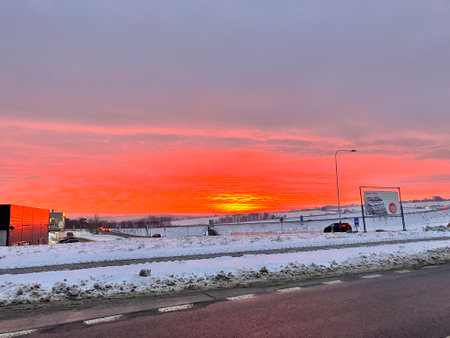 Sunset over a highway in winter with a lot of snow.の写真素材