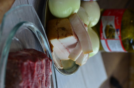 Raw meat and olives on a cutting board. Selective focus.の写真素材