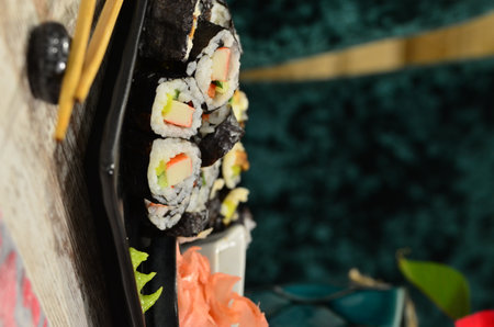 Sushi roll with salmon, avocado, cucumber, cream cheese, nori, tobiko caviar, nori, nori seaweed. Sushi menuの写真素材