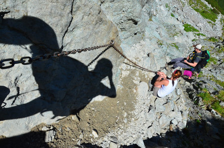 Climbing in the Swiss Alps on a summer day with the help of a group of climbers, Mountains, Tatry,...