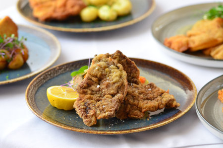 Schnitzel with salad in a plate on the table.