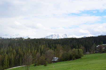 mountains under snow, a beautiful panorama of the High Polish Tatras, Mount Giewont, the green valley below Gubalowka near the city of Zakopane,の写真素材