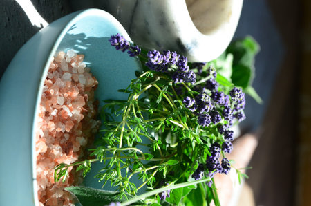 Spa composition with lavender, sea salt and herbs on a table