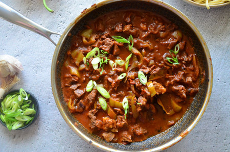 Beef Stroganoff in a frying pan on a wooden table