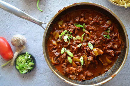 Beef Stroganoff in a frying pan on a wooden table