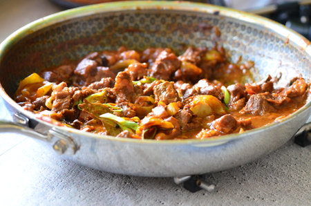 Thai style beef casserole with vegetables in a pan.の写真素材