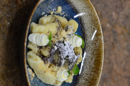 food background, Czech cuisine, served food, potato gnocchi sprinkled with poppy seeds and cottage cheese,の写真素材