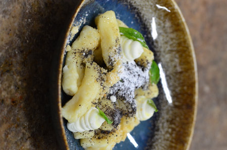 potato gnocchi, with poppy seeds and fresh fruitの写真素材