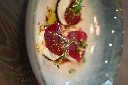 Beef tartare with berry sauce on a white plate.