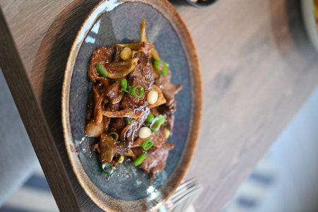 Beef stewed with vegetables and spices on a plate in a restaurant, bulgogi