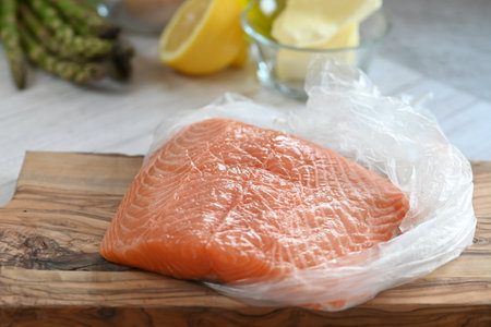 High-quality raw salmon fillet with a vibrant orange hue, beautifully arranged on a light backgroundの写真素材