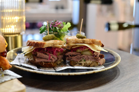 sandwich with roast beef and pickled cucumbers on a plateの写真素材