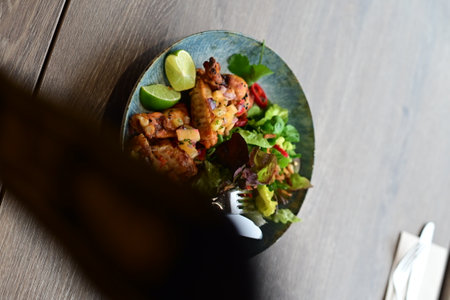 Closeup of a plate of chicken kebab served with limeの写真素材