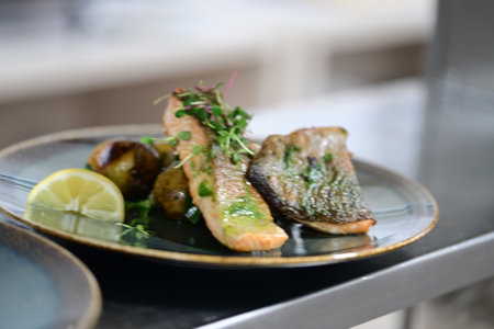 Fried mackerel fillet with lemon and microgreensの写真素材