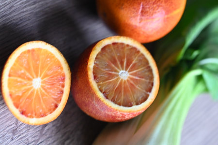 Slices of red blood oranges and celery on wooden backgroundの写真素材