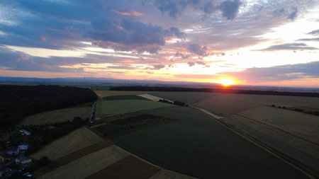 Aerial view of a sunset over the fields in the countryside.の写真素材