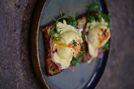 Eggs benedict with hollandaise sauce on toastの写真素材